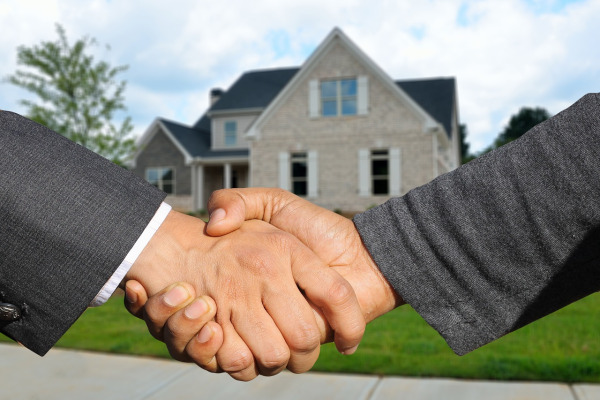 estate agent handshake property purchase